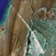 Illustration for article titled The World's Longest Conveyor Belt System Can Be Seen From Space